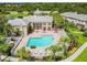 Aerial view of a clubhouse and swimming pool with surrounding landscaping at 7632 Plantation Cir, Bradenton, FL 34201