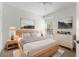 Cozy bedroom featuring a queen bed, neutral tones, and contemporary artwork at 7632 Plantation Cir, Bradenton, FL 34201