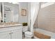 Cozy bathroom featuring a granite vanity top, tiled shower with tub and shower curtain plus modern fixtures at 8271 Redonda Loop, Lakewood Ranch, FL 34202