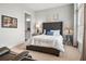 Comfortable bedroom with plush carpeting, a tufted headboard, and soft lighting for a relaxing ambiance at 8271 Redonda Loop, Lakewood Ranch, FL 34202