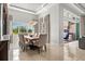 Spacious dining area with a large window, modern lighting, and stylish decor at 8271 Redonda Loop, Lakewood Ranch, FL 34202