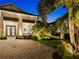 Attractive home featuring a brick paver driveway and tropical landscaping at 8271 Redonda Loop, Lakewood Ranch, FL 34202