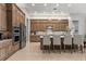 Spacious kitchen with wooden cabinets, a large island, and stainless steel appliances at 8271 Redonda Loop, Lakewood Ranch, FL 34202