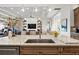 Open concept kitchen featuring marble counters, a stainless steel sink, and pendant lighting at 8271 Redonda Loop, Lakewood Ranch, FL 34202