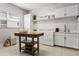 Well-organized laundry room with modern appliances and decorative backsplash at 8271 Redonda Loop, Lakewood Ranch, FL 34202