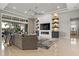 Living room showcasing a fireplace, shelving, and access to screened outdoor space at 8271 Redonda Loop, Lakewood Ranch, FL 34202