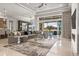 Spacious living room with elegant furnishings and sliding glass doors to the outdoor area at 8271 Redonda Loop, Lakewood Ranch, FL 34202