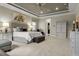 The primary bedroom features a neutral color palette, tray ceilings, and an ensuite bathroom at 8271 Redonda Loop, Lakewood Ranch, FL 34202