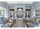 An outdoor lounge provides ample seating, a fireplace, and tiled flooring for stylish community relaxation at 8271 Redonda Loop, Lakewood Ranch, FL 34202