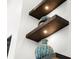 Modern shelving design with accent lighting and decorative vases at 8271 Redonda Loop, Lakewood Ranch, FL 34202