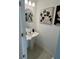 Stylish powder room with pedestal sink and decorative wall art at 8949 Daybreak St, Sarasota, FL 34241