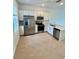 Modern kitchen featuring stainless steel appliances, white cabinetry, and tile flooring at 8949 Daybreak St, Sarasota, FL 34241