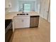 Beautiful kitchen view showcasing stainless steel appliances and island with a sink at 8949 Daybreak St, Sarasota, FL 34241