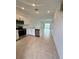 Open-concept kitchen with stainless steel appliances and view of the living area at 8949 Daybreak St, Sarasota, FL 34241