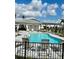 Community pool with shaded gazebo, lounge chairs, tables, and lush landscaping offers a relaxing outdoor space at 8949 Daybreak St, Sarasota, FL 34241
