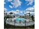 Beautiful community pool with abundant lounge seating, a gazebo and swaying palm trees under sunny skies at 8949 Daybreak St, Sarasota, FL 34241