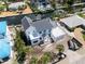 Aerial view of a canal-front home featuring a backyard pool, new dock, and modern, light-filled architecture at 927 Contento St, Sarasota, FL 34242