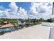 An aerial view of the home, canal, boat lift, and lush surroundings at 927 Contento St, Sarasota, FL 34242
