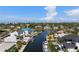 Beautiful aerial view of canal-front homes, with private docks, boat lifts, and ocean views on a sunny day at 927 Contento St, Sarasota, FL 34242
