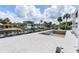 Wide angle shot of backyard with in-ground pool, dock and access to beautiful canal at 927 Contento St, Sarasota, FL 34242