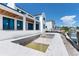 New construction backyard featuring an in-ground pool, outdoor kitchen area and access to the water at 927 Contento St, Sarasota, FL 34242