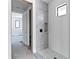 Bathroom with a glass-enclosed shower with white tile and a built-in niche at 927 Contento St, Sarasota, FL 34242