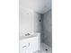 Modern bathroom featuring gray tile shower and white vanity with drawers at 927 Contento St, Sarasota, FL 34242
