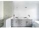 Bathroom with dual sink vanity, granite counters, and marble backsplash at 927 Contento St, Sarasota, FL 34242