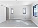 Light-filled bedroom featuring three windows, modern trim and closet with sliding doors at 927 Contento St, Sarasota, FL 34242