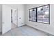 A bright bedroom featuring a large black frame window with white trim and an open door at 927 Contento St, Sarasota, FL 34242