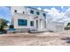 Contemporary two-story home showcasing a pristine white exterior with dark window frames at 927 Contento St, Sarasota, FL 34242