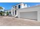 Modern two-story home with an attached two-car garage featuring a clean white exterior at 927 Contento St, Sarasota, FL 34242