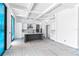 Modern kitchen features a gray island, sleek white cabinets, marble backsplash and stunning coffered ceilings at 927 Contento St, Sarasota, FL 34242