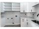 Bright laundry room with white cabinets, quartz counters, and a sink and faucet at 927 Contento St, Sarasota, FL 34242