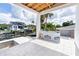Outdoor patio with tile flooring and views of the canal, dock, and a luxurious neighboring home at 927 Contento St, Sarasota, FL 34242