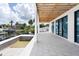 Extended patio with tile floors overlooks canal, boat dock and lift, and has access via sliding glass doors at 927 Contento St, Sarasota, FL 34242