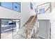 A staircase featuring white walls and large windows at 927 Contento St, Sarasota, FL 34242
