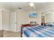 This bedroom features a ceiling fan, mounted TV, and a closet with mirrored sliding doors at 11744 Shirburn Cir, Parrish, FL 34219