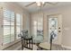 Bright breakfast nook features a glass table, shuttered windows and a decorative glass paneled door at 11744 Shirburn Cir, Parrish, FL 34219