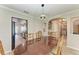 Elegant dining room with wood floors, views of kitchen and laundry room at 11744 Shirburn Cir, Parrish, FL 34219