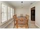 Dining room with natural light, wood floors, and classic dining set at 11744 Shirburn Cir, Parrish, FL 34219
