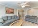 Cozy living room with light wood floors, comfortable sofas, and an inviting atmosphere at 11744 Shirburn Cir, Parrish, FL 34219
