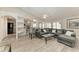 Inviting living room with vaulted ceiling provides seamless flow to kitchen, dining, and staircase at 11744 Shirburn Cir, Parrish, FL 34219