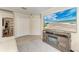 Living room includes wood-look flooring, a wall-mounted tv and a view into another room at 11744 Shirburn Cir, Parrish, FL 34219