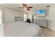 Bright main bedroom with wood-look floors, light-colored furniture, and a ceiling fan at 11744 Shirburn Cir, Parrish, FL 34219
