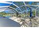 Expansive screened-in lanai with multiple seating areas and pool, ideal for outdoor living and entertaining at 11744 Shirburn Cir, Parrish, FL 34219