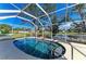 Relaxing screened-in pool with spa overlooks the serene pond views for a tranquil outdoor experience at 11744 Shirburn Cir, Parrish, FL 34219