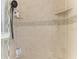 Close up of the tiled shower featuring mosaic tile accents and multiple toiletry shelves at 11744 Shirburn Cir, Parrish, FL 34219