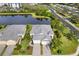 Aerial view of home, showcasing landscaped grounds, tile roof, and beautiful pond at 12019 Sawgrass Lake Ter, Bradenton, FL 34211