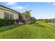 Inviting backyard with lush green lawn, patio area and lovely water view at 12019 Sawgrass Lake Ter, Bradenton, FL 34211